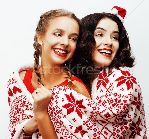 young pretty happy smiling blond and brunette woman girlfriends on christmas in santas red hat and h Stock photo © iordani
