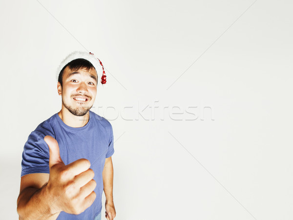 Stock photo: funy exotical asian Santa claus in new years red hat smiling