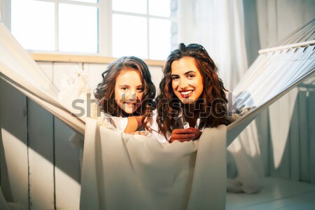 woman with children in garden hanging laundry outside, lifestyle Stock photo © iordani