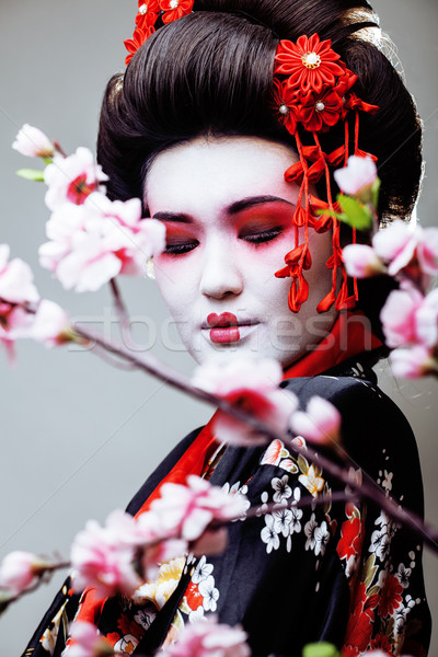 Giovani bella geisha nero kimono sakura Foto d'archivio © iordani
