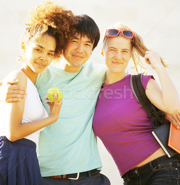 cute group of teenages at the building of university with books huggings, diversity nations Stock photo © iordani