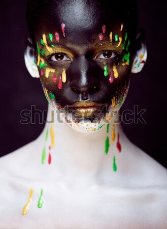 Stock photo: woman with creative makeup closeup like drops of colors, facepai