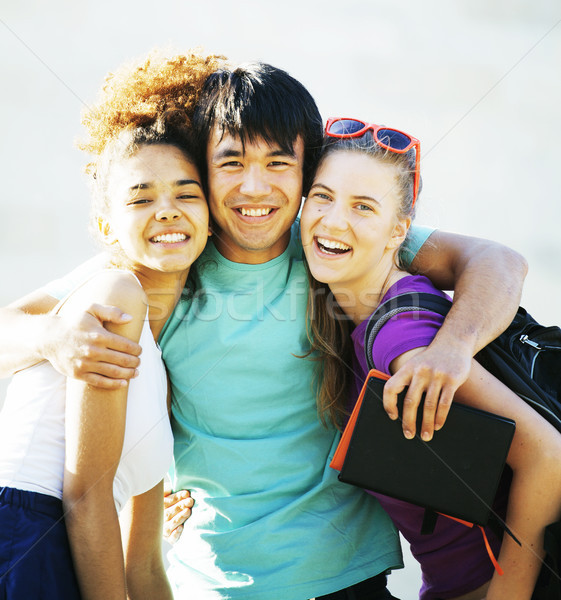 cute group of teenages at the building of university with books huggings Stock photo © iordani