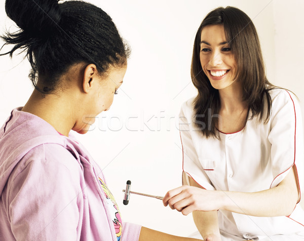 young smiling doctor examine patient, measuring pressure Stock photo © iordani