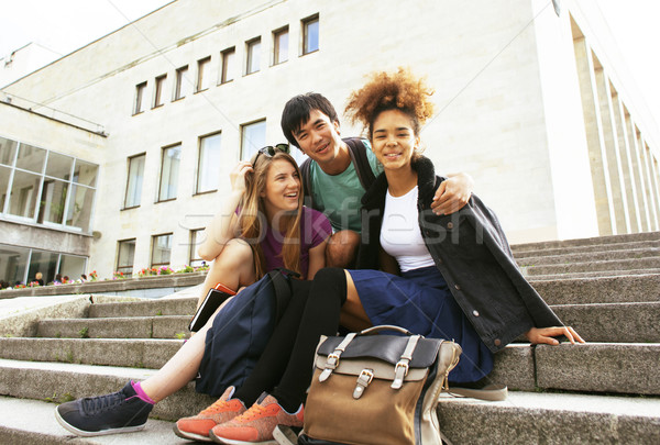 cute group of teenages at the building of university with books  Stock photo © iordani