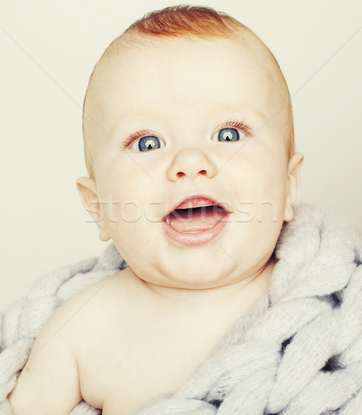 little cute red head baby in scarf all over him close up isolate Stock photo © iordani