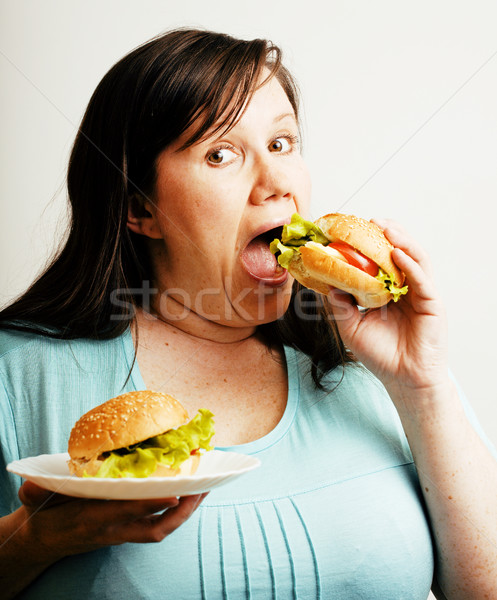 fat white woman having choice between hamburger and salad Stock photo © iordani