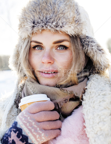 young pretty teenage hipster girl outdoor in winter snow park having fun drinking coffee, warming up Stock photo © iordani