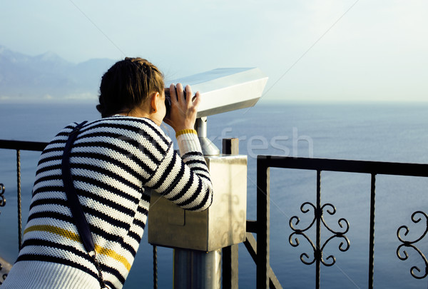 young woman looking through telescope at sea viewpoint in Ataturk park Stock photo © iordani