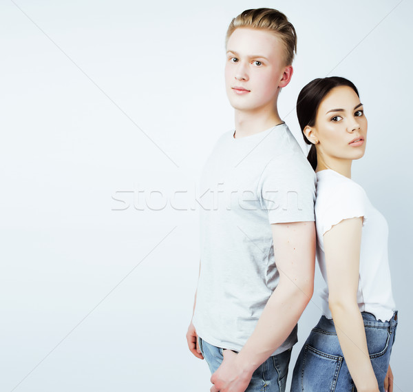 young pretty teenage couple, hipster guy with his asian girlfriend happy smiling and hugging isolate Stock photo © iordani