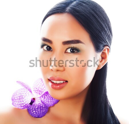 Stock photo: young pretty asian woman with flower purple orchid closeup isola