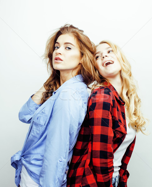 two pretty blond woman having fun together on white background, mature mother and young teenage daug Stock photo © iordani