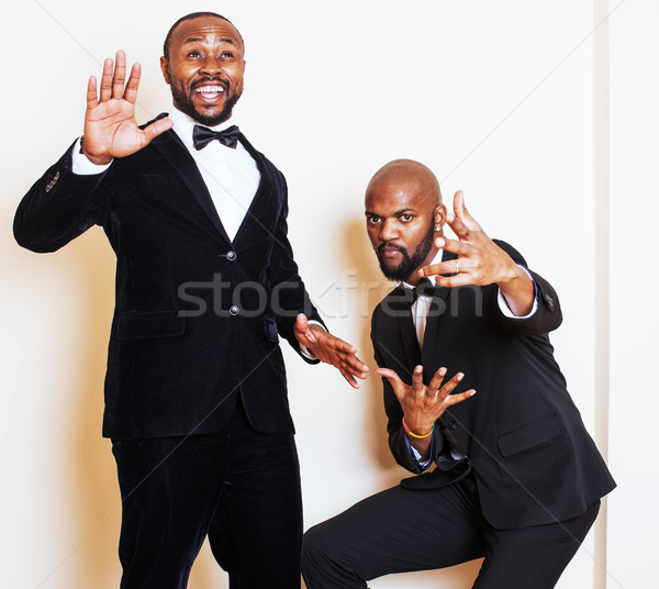 two afro-american businessmen in black suits emotional posing, gesturing, smiling. wearing bow-ties Stock photo © iordani