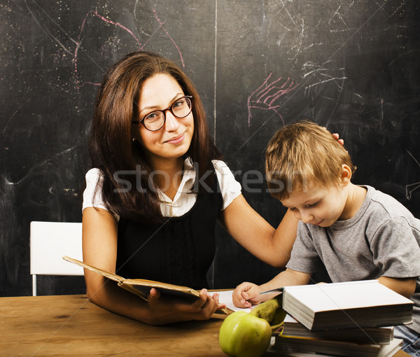 little cute boy with young teacher in classroom studying at blac Stock photo © iordani