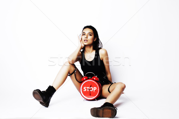 young pretty indian girl with red alarm clock posing cheerful on white background isolated, sexy mod Stock photo © iordani