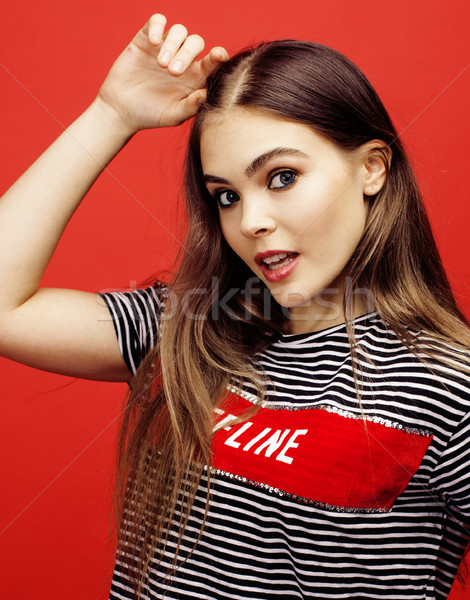 young pretty emitonal posing teenage girl on bright red background, happy smiling lifestyle people c Stock photo © iordani