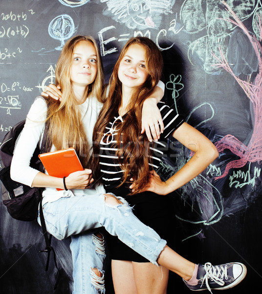 back to school after summer vacations, two teen real girls in classroom with blackboard painted toge Stock photo © iordani