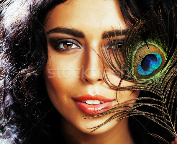 young sensitive brunette woman with peacock feather eyes close up Stock photo © iordani