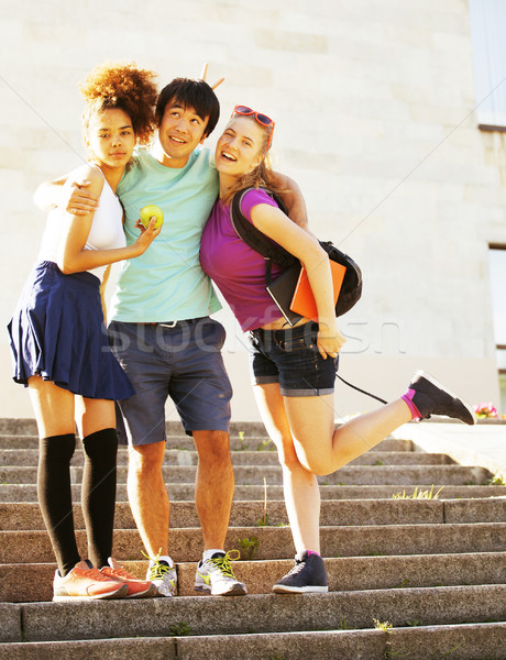 cute group of teenages at the building of university with books huggings Stock photo © iordani