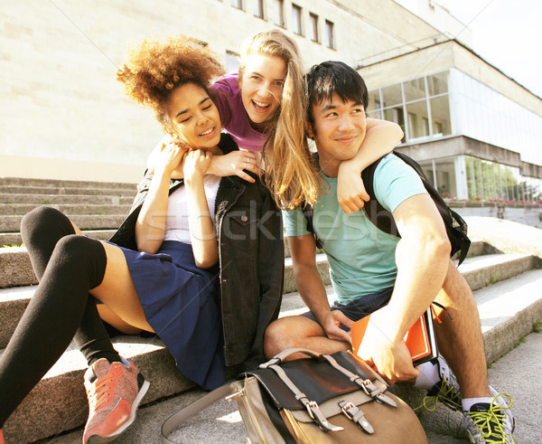 cute group teenages at the building of university with books huggings, back to school Stock photo © iordani