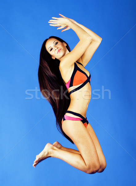 young pretty brunette girl in bikini smiling studio blue background close up Stock photo © iordani