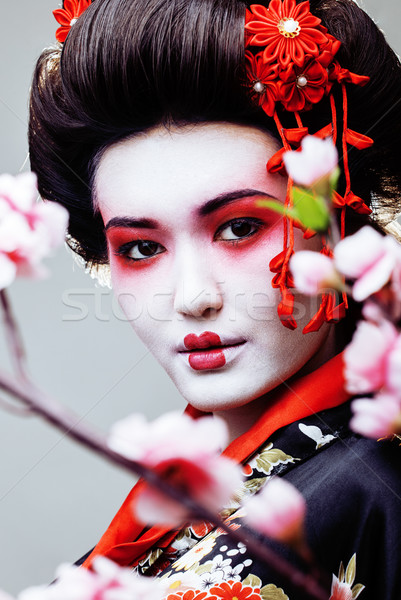 Fiatal csinos gésa fekete kimonó sakura Stock fotó © iordani