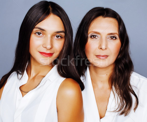 cute pretty teen daughter with mature mother hugging fashion
