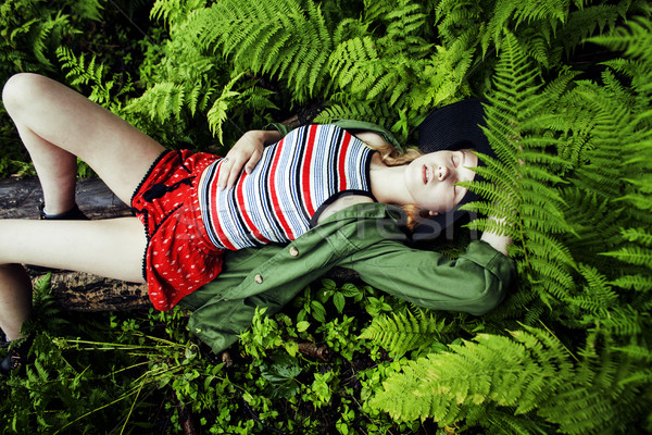 Pretty young blond girl hipster in hat among fern, vacation in g Stock photo © iordani