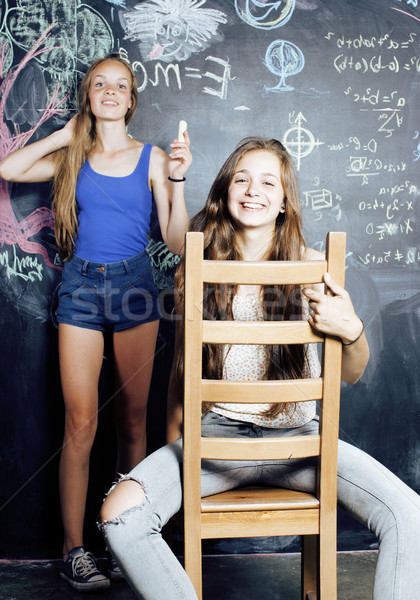 back to school after summer vacations, two teen real girls in classroom with blackboard painted toge Stock photo © iordani