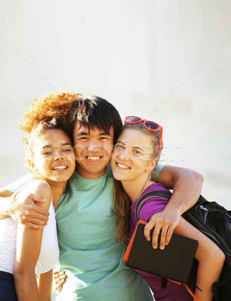 cute group of teenages at the building of university with books huggings, back to school Stock photo © iordani