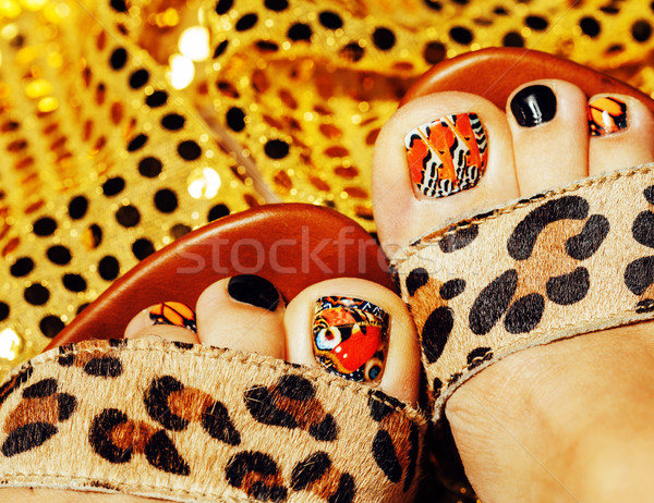 photo of pedicure like butterfly design on gold background close Stock photo © iordani