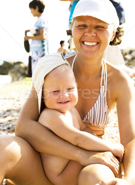 portrait of happy mother with little baby son on beach, lifestyle people concept Stock photo © iordani