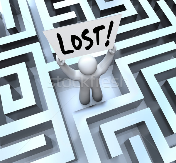 Lost Man Holding Sign in Labyrinth Maze Stock photo © iqoncept