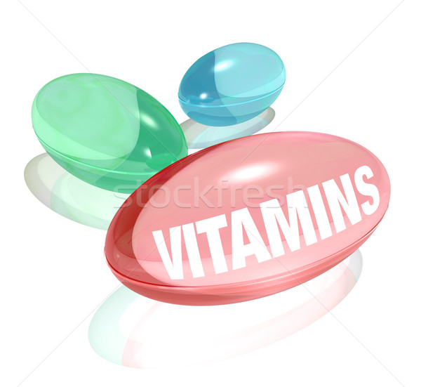 Vitamins on White Background and Word on Capsule Stock photo © iqoncept