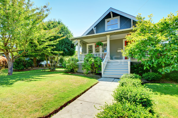 Grey small old American house front exterior with white staircase. Stock photo © iriana88w