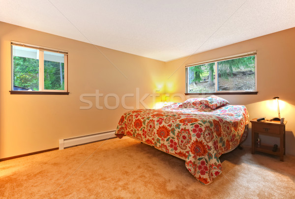 Beautiful beige bedroom with colourful bedding, nightstand. Stock photo © iriana88w