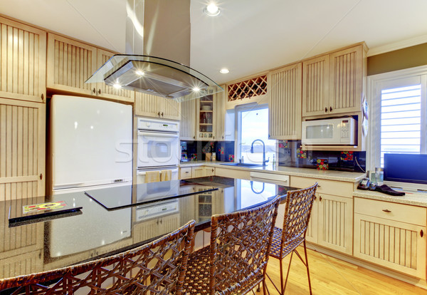 Bright cozy kitchen with beige cabinets and white ceiling Stock photo © iriana88w