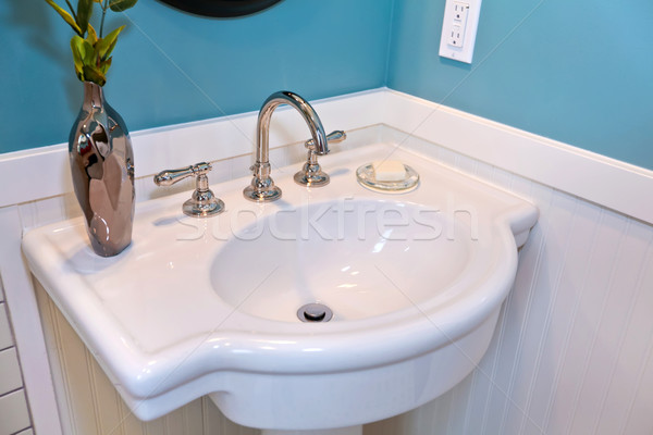 Stock photo: Beautiful white sink with blue walls and plank wall trim.