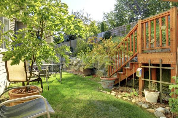 Small green fenced back yard with garden and wooden staircase. Stock photo © iriana88w
