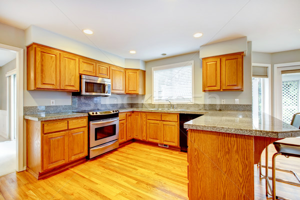Stock photo: New classic wood large kitchen with grey countertop.