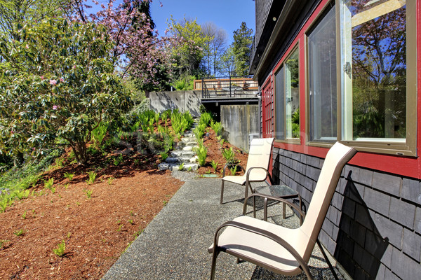 Spring Back yard with two chairs and black wood house. Stock photo © iriana88w