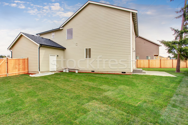 Luxury back yard with unfurnished patio and grass. Stock photo © iriana88w