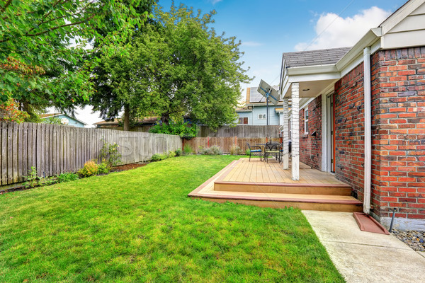 Stock photo: Brick house exterior with walkout wooden deck