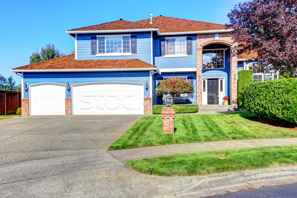 Light blue house exterior with brick trim and tile roof Stock photo © iriana88w