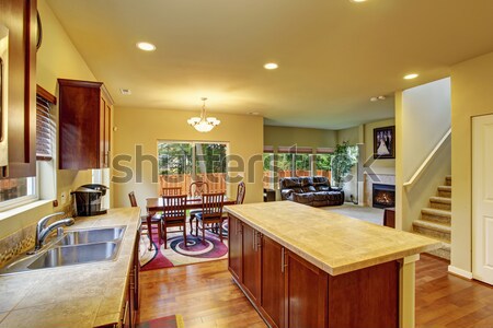Stock photo: Luxury mohogany Kitchen with modern furniture and stone fireplace.