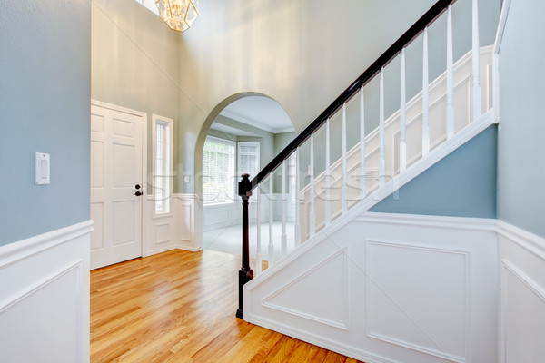 Stock photo: Blue empty entrace with white molding and staircase.