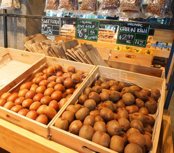 Boxes with golden and green kiwi at natural food market in Auckl Stock photo © iriana88w