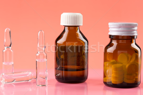 Brown glass pill bottles and three medicine ampules Stock photo © ironstealth