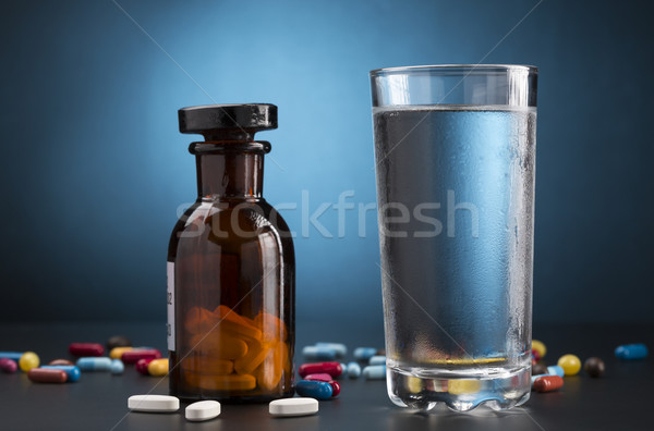 Medicine pills bottle and glass of drink water Stock photo © ironstealth