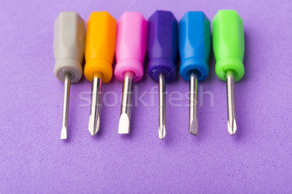 Mini colored screwdriver set on purple background Stock photo © ironstealth